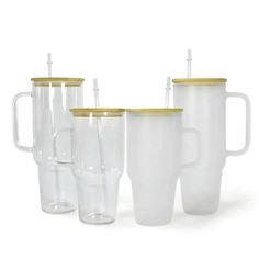 four plastic cups with gold rims and lids