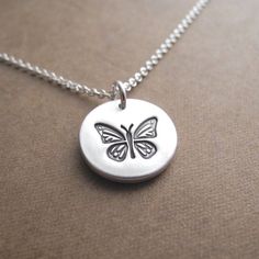 My Butterfly Necklace is handcrafted in fine silver and features my new butterfly design. It has a satin finish and the back is stamped with my dragonfly maker's mark and ".999" to signify fine silver.  Your choice of sterling silver chain is included.S I Z E :  Approx. 5/8" in diameter (16 mm) - a little smaller than a dime.A V A I L A B I L I T Y :  Made-to-order, ships 1-2 weeks after purchase unless otherwise noted above.Because I make each one by hand, yours will vary slightly from the abov Silver Adjustable Butterfly Necklace For Gift, Silver Butterfly Charm Necklace For Everyday, Adjustable Silver Butterfly Pendant Necklace, Silver Adjustable Butterfly Pendant Necklace, Personalized Silver Butterfly Pendant Necklace, Adjustable Nickel Free Butterfly Necklace, Adjustable Nickel-free Butterfly Necklace, Everyday Sterling Silver Butterfly Jewelry, Engraved Butterfly Necklace For Gifts