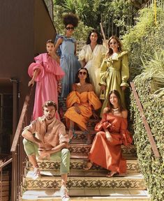 a group of women and men posing on steps