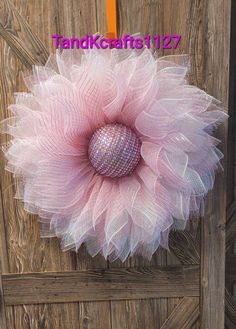 a pink and white flower on top of a wooden door with the words thankcraftist 12