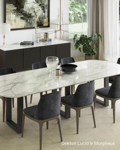 a marble dining table surrounded by black chairs