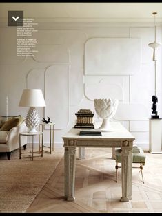 a living room filled with furniture and a white vase on top of a coffee table