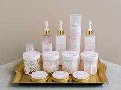 an assortment of beauty products displayed on a tray