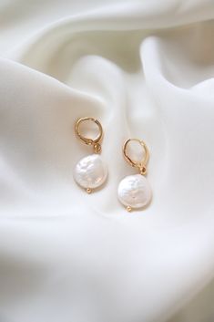 Our new Pearl Huggie Earrings have quickly become best sellers, they make great gifts and are so on trend. 18K gold plated hoop with natural pearl accent. Buy Pearls, Daisy Studs, Bridal Earrings Pearl, Spike Earrings, Social Enterprise, Pearl Hoop Earrings, Natural Pearl, Business Model, Pearl Charms