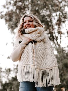 a woman wearing a white scarf with fringes