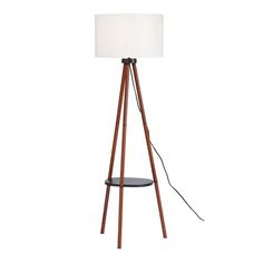 a wooden tripod floor lamp with a white shade on the top and black base