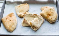 some pita bread is on a baking sheet