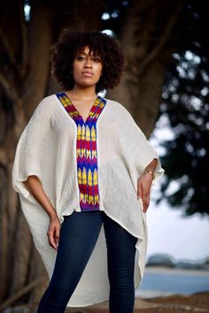 Boldly Cozy With A Boho Twist. Simply-Chic Layering piece, that dresses up or down for any occasion.• V-Neck and flattering drape• 100% Cotton • V-neck • Embroidery By Hand In Ethiopia. • Made in California.• size one size fits most { the size is loose fit it well fit from size 2 to size 12 } • front length 23” from the shoulder. • Machine wash In Delicate cycle or hand was in cold water. Tumble dry low heat for crinkle look. • Color off white / beige/ the embroidery is multi color. Oversized Bohemian Short Sleeve Blouse, Free Size Short Sleeve Blouse, Casual Free Size Tunic With Batwing Sleeves, Bohemian Oversized Tunic Tops, Oversized Bohemian Tunic Tops, Free Size Casual V-neck Tunic, Oversized Tunic Top For Vacation, Oversized Short Sleeve Poncho, Free Size Tunic Top For Vacation