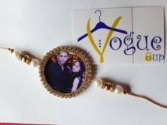 an image of a woman and man on a beaded bracelet with a business card in the background