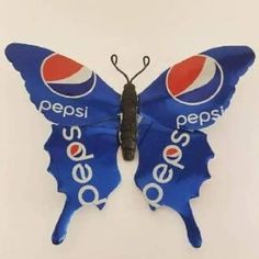 a butterfly shaped pepsi bottle opener with the word pepsi on it's back and wings