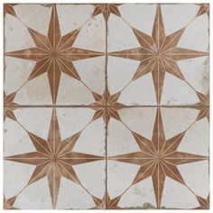 a white and brown tiled wall with star designs on the top, bottom and bottom