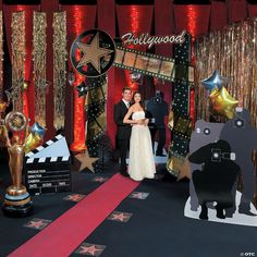 a newly married couple standing in front of hollywood backdrop