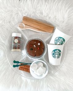 starbucks coffee, marshmallows and cookies on a plate