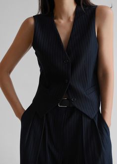 Color: Navy PinstripeTraditional suiting fabricFitted waistcoat Button front closureV-necklineFront welt pocketsAdjustable belted backLined72% Polyester 22% Rayon 4% Wool 2% SpandexDry CleanBy The Frankie Shop. Imported