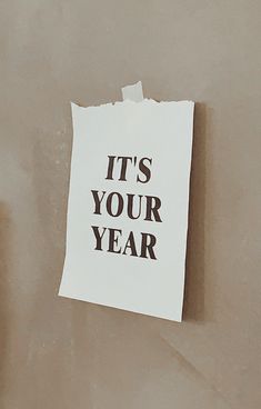 a piece of paper with the words it's your year written on it next to a toilet