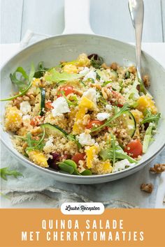 quinoa salad with meat, cherry tomatoes and feta cheese in a bowl