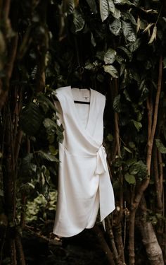 a white shirt hanging from a tree in the woods