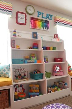 a child's playroom with lots of toys and bookshelves in it