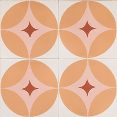 four orange and white tiles with circles on one side, the other half in brown