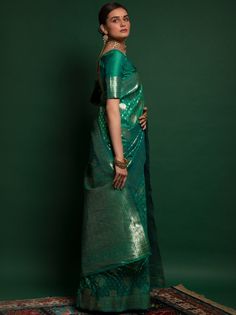 <ul>
<li>Presenting a gorgeous amalgamation of India's rich culture and tradition this unique green-colored silk saree is created with zari weaving all over the saree and also have thread zalar lace on the edge.</li>
<li>The saree arrives with a similar colored silk fabric half sleeve and V shape design blouse made up of zari weaving work.</li>
<li>This lovely green-colored silk saree is 5.50 meters long and comes with unstitched blouse material.</li>
&l Green Zari Work Kurta In Cotton Silk, Green Cotton Silk Kurta With Zari Work, Green Tussar Silk Pre-draped Saree With Dupatta, Green Pre-draped Saree With Dupatta, Green Tussar Silk Pre-draped Saree, Green Cotton Silk Blouse Piece With Dupatta, Festive Green Chanderi Pre-draped Saree, Green Cotton Silk Dupatta For Navratri, Green Cotton Silk Lehenga With Zari Work