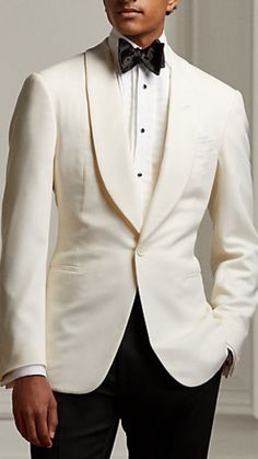 Man wearing a white tuxedo blazer with black pants. He is wearing a black bowtie and a white collard shirt to complete the look. Classy Men Outfits Gentleman Style, Classic Suits For Men, White Tuxedo Men, Dapper Men Outfits, Black Tuxedo Wedding, Ivory Tuxedo, Classic Suits, Suit Prom, Prom Suit