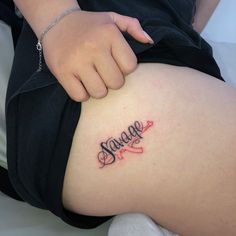 a woman's stomach with the word strange tattooed on her lower thigh and hand