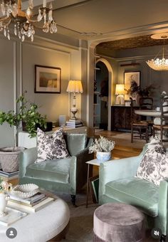 a living room filled with furniture and a chandelier