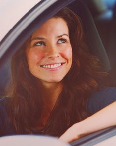 a woman sitting in the passenger seat of a car