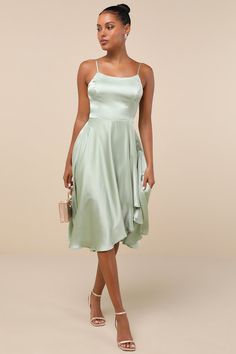 We hope every day can feel like the ones we spend in the Lulus Days Like Today Sage Satin Asymmetrical Tie-Back Midi Dress! Textured woven satin creates a princess-seamed bodice with an apron neckline and a tying back cutout, supported by adjustable spaghetti straps. High waist tops a flowy midi skirt with an asymmetrical hem. Fit: This garment fits true to size. Length: Mid-calf length. Size medium measures 40.5" from adjustable straps to hem. Bust: Great for any cup size. Waist: Fitted - very Midi Dress Satin, Flowy Midi Skirt, Tea Length Bridesmaid Dresses, Midi Dress Green, Asymmetrical Midi Dress, Semi Formal Dress, Green Bridesmaid Dresses, Dress Satin, Satin Midi Dress