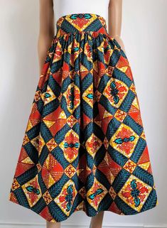 Handmade Unlined African Print Midi Skirt     Elastic waist band skirt at the back      2 open side-entry pockets     Exact length: 33"      100% Wax Cotton     Handmade     Made in the UK (Colours may vary due to lighting on images. The product images are closest to the true colour of the product.) African Print Midi Skirt, Mid Calf Skirt, African Clothes, Handmade Uk, African Prints, Waxed Cotton, African Clothing, Product Images, Waist Band