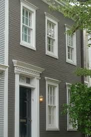 a black and white house with three windows