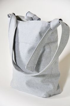 This shoulder bag is crafted from 100% sustainable eco-cotton, in a light blue upcycled denim material. Perfect for everyday use, to hold all of your essentials. Casual Travel Shoulder Bag Made Of Recycled Materials, Versatile Cotton Shoulder Bag For Daily Use, Denim Blue Cotton Shoulder Bag For Everyday Use, Versatile Everyday Cotton Shoulder Bag, Everyday Denim Blue Canvas Shoulder Bag, Everyday Gray Canvas Bag With Adjustable Strap, Denim Blue Cotton Bags For Everyday Use, Denim Blue Cotton Bag For Daily Use, Practical Cotton Shoulder Bag With Leather Handles