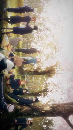 a group of people standing next to each other in front of a body of water