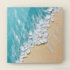 an aerial view of the ocean and beach with waves crashing on it's shore