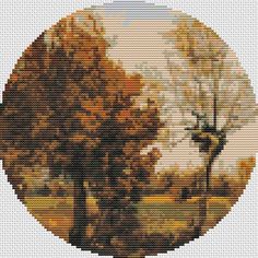 a cross stitch picture of two trees in the fall with yellow leaves on them and one tree without leaves