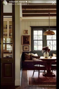 a dining room table and chairs in front of a window