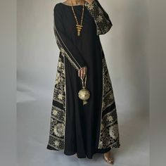 Black Double Sided Jalabiya With Light Gold Embroidery & Light Gold Piping. The Jalabiya Is A Double A-Cut Cut. Size Medium, 54” Long Sleeve Abaya With Dabka Work For Evening, Evening Abaya With Dabka Work And Long Sleeves, Traditional Black Maxi Dress For Festive Occasions, Black Kaftan With Dabka Work For Eid, Black Dabka Work Kaftan For Eid, Traditional Abaya With Chikankari Embroidery For Eid, Traditional Chikankari Embroidery Abaya For Eid, Eid Black Kaftan With Dabka Work, Black Embroidered Abaya For Wedding