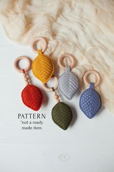 four crocheted acorns with wooden handles on a white surface and text that says pattern not a ready made item