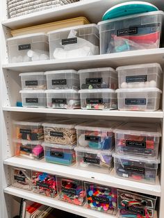 an organized closet with plastic bins and craft supplies