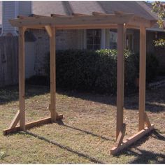 a wooden structure sitting in the middle of a yard