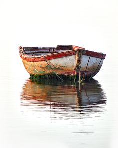 an old boat is sitting in the water