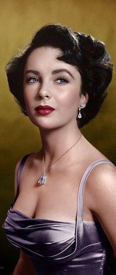 an old black and white photo of a woman in a dress with large earrings on her head