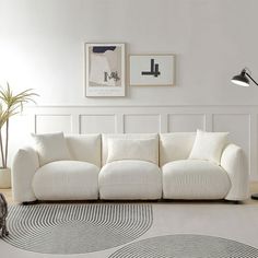 a large white couch sitting in a living room