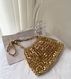 Add a touch of luxury and style to your outfit with our Gold Beaded Handbag. Featuring a stunning gold woven design and a chic strap, this bag is sure to catch the eye. Elevate any look and make a statement with this must-have accessory. ALL SALES ARE FINAL SOLD AS SHOWN