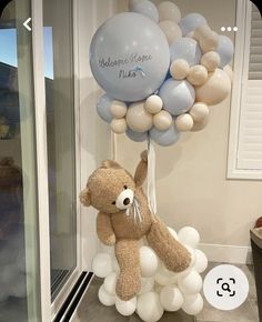 a teddy bear holding onto some balloons