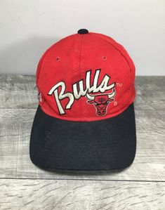 Up on ETSY for buy it now is a Up for sale is a good condition, Vintage Chicago Bulls Red Script Sports Specialties Hat Cap Fitted. Size 6 3/4. Made in Korea. Haven't tried to clean. Sold as is gently used.  Please check out the pictures. If you need more pictures or information regarding the item, please send them to me. Please keep in mind that all of my items are vintage, gently used, unless otherwise indicated in the listing. Like what see out of my listings, check us out and "Like" us on Fa Classic Sports Visor Fitted Hat, Classic Snapback Visor Hat For Sports Events, Classic Red Snapback Hat For Sports, Classic Visor Snapback Hat For Sports Events, Classic Visor Fitted Hat For Sports, Classic Red Fitted Hat For Sports, Red Sporty Hat For Sports Events, Sporty Red Fitted Hat For Sports Events, Red Sporty Fitted Hat For Sports Events