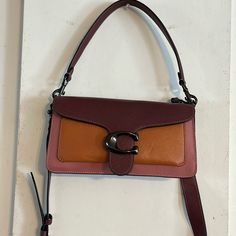 Coach Tabby Shoulder Bag 26 New Missing Tag, Never Used The Color Is Orange/Dark Brownish Red Or Burgandy. Dust Bag Included. Measurements Length: 10.25" Height: 5.5" Width: 2.75" Materials Polished Pebble Leather Leather Lining Strap Detachable Short Strap With 7" Drop Detachable Long Strap With 21" Drop For Shoulder Or Crossbody Wear Features Inside Zip Pocket Snap Closure Inside Multifunction Pocket Smoke-Free Home Purple Coach Satchel With Detachable Strap, Coach Purple Satchel With Detachable Strap, Coach Burgundy Shoulder Bag With Adjustable Strap, Orange Leather Coach Bag, Orange Crossbody Shoulder Bag With Detachable Strap, Rectangular Purple Coach Shoulder Bag, Coach Purple Shoulder Satchel, Coach Orange Rectangular Bag, Coach Purple Shoulder Bag With Adjustable Strap