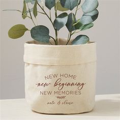 a plant in a bag that says new home, new beginning and new memories