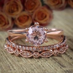 two rose gold wedding rings with an oval morganite in the center