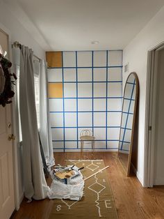 the room is being decorated with blue and yellow wallpaper, along with a chair